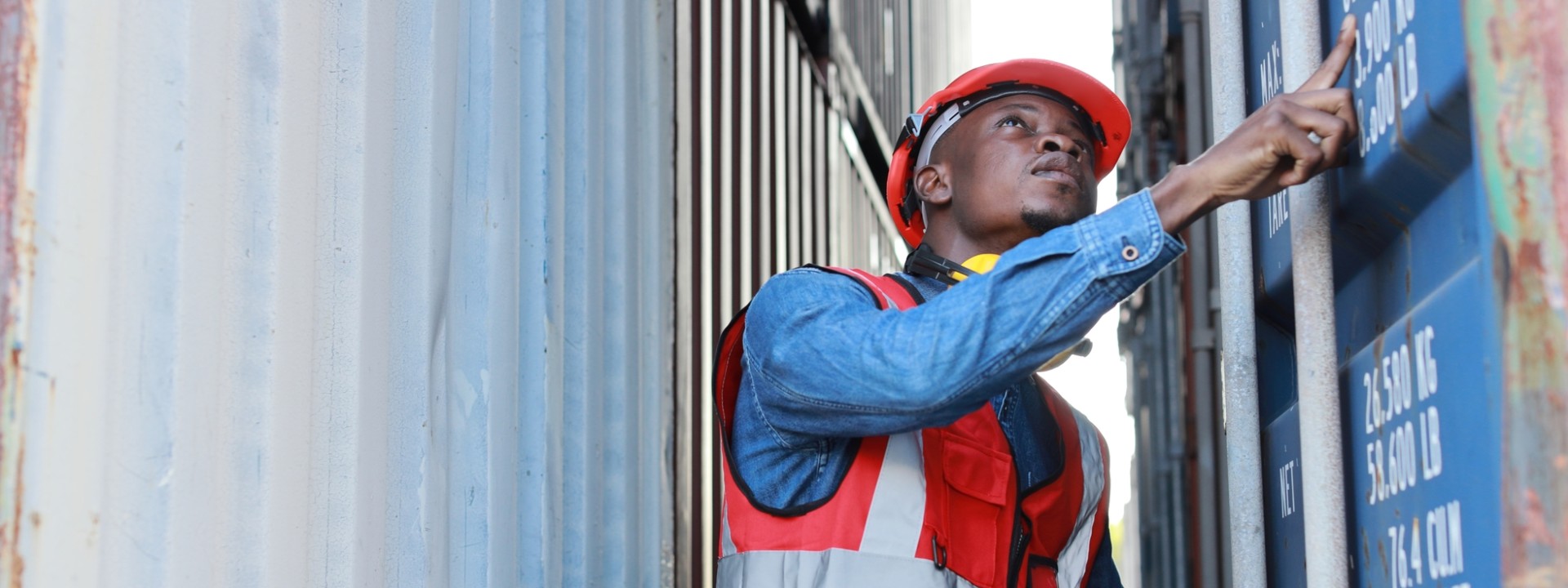 Man opening a container at a harbour