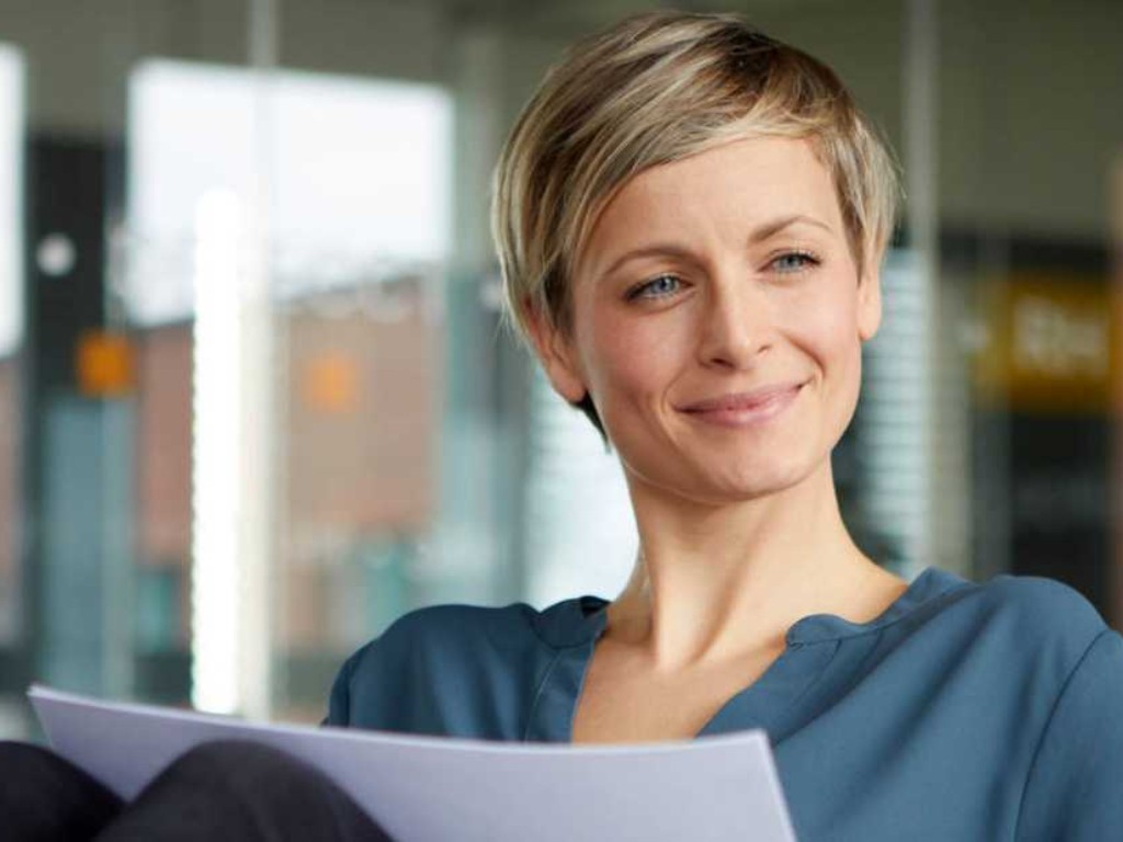 Smiling woman in front of laptop