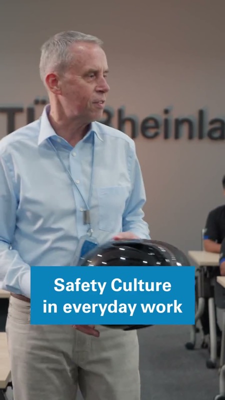 Video: Man at a training session holding a safety helmet with text overlay about safety culture