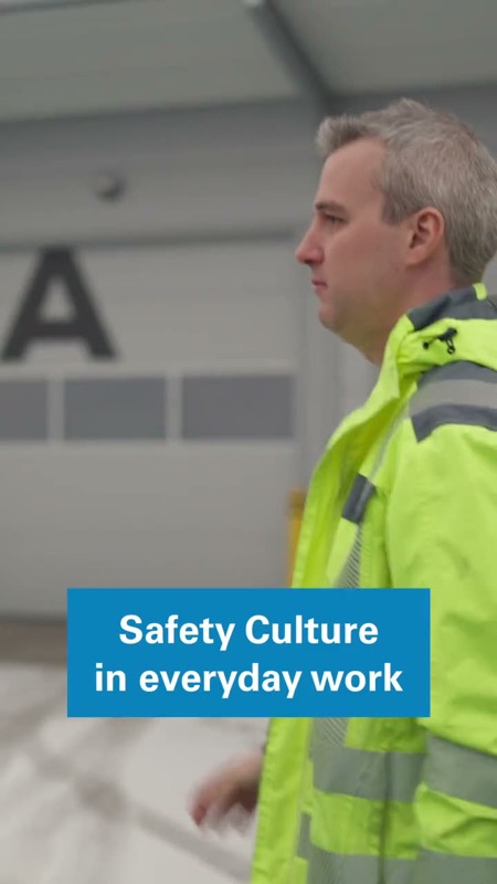 Video: Man in a high-visibility jacket at an industrial facility with text overlay about safety culture