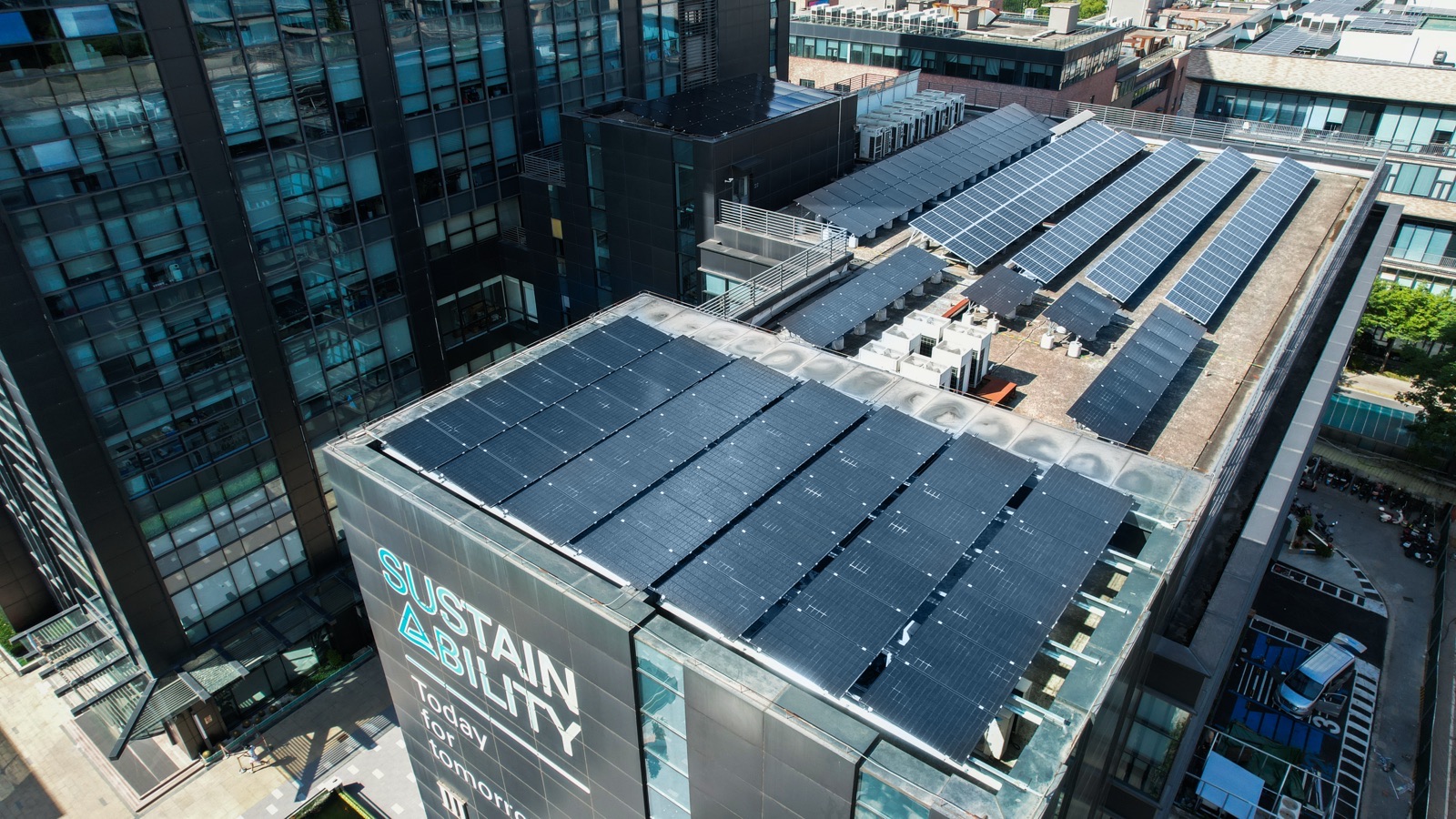 Aerial view of TÜV Rheinland building in Greater China with rooftop photovoltaic system and sustainability signage